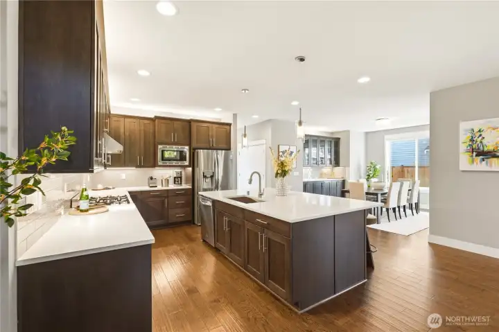 A chef's kitchen built for real entertaining: oversized island with seating, custom cabinetry, and high-end appliances.