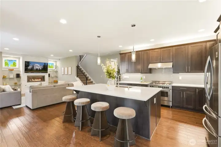 The open floor plan connects the living room, kitchen, and dining area in one effortless, elegant space.