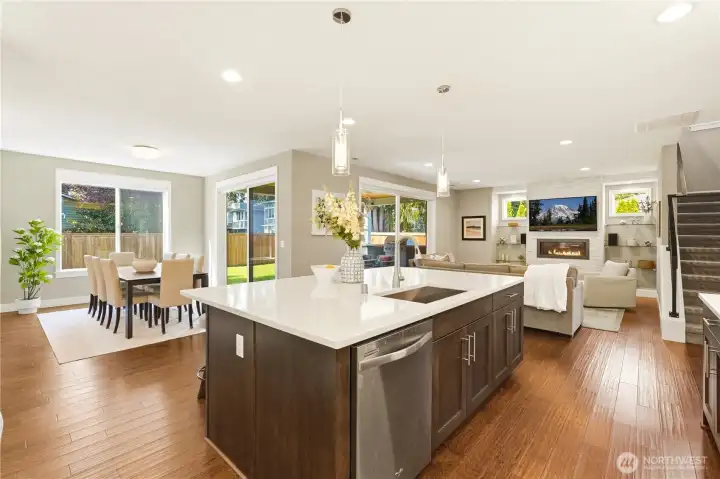 From the kitchen, the dining and living areas open naturally to the covered patio through two sets of sliding glass doors.