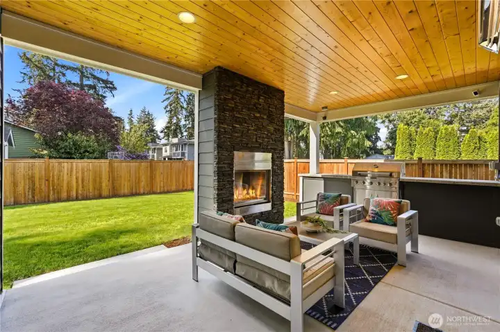 The covered patio is made for year-round enjoyment, with an infrared heater and gas fireplace.