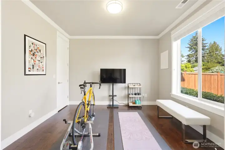 A flexible main-level den or office, currently used as an exercise room.
