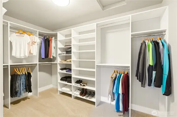 A well-organized walk-in closet with space for everything.