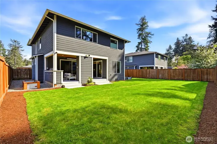 A level, fully fenced backyard with plenty of sun and room to garden.