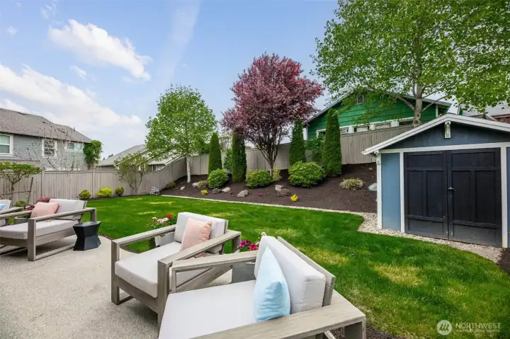 Dream yard with oversized patio, lush landscaping, mature trees, sprinker system and uplighting