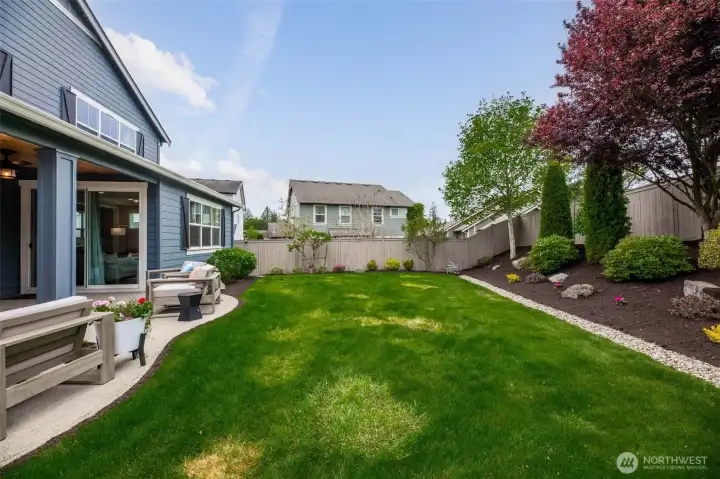 Dream yard with oversized patio, lush landscaping, mature trees, sprinker system and uplighting