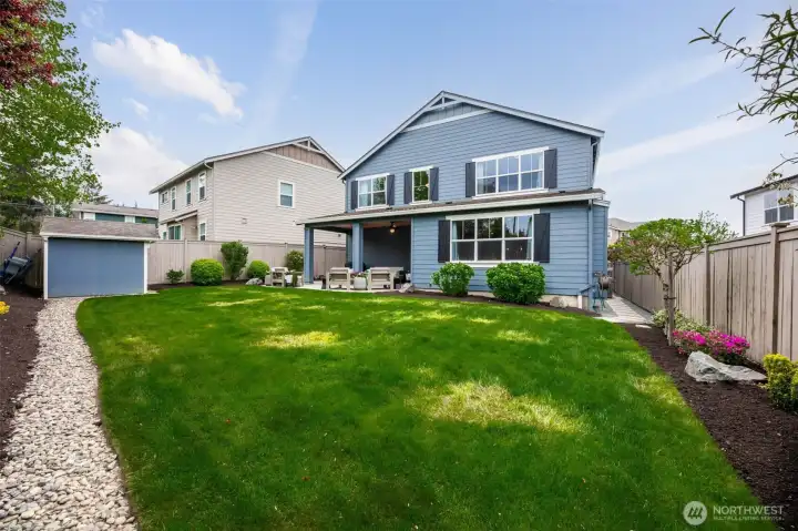 Dream yard with oversized patio, lush landscaping, mature trees, sprinker system and uplighting