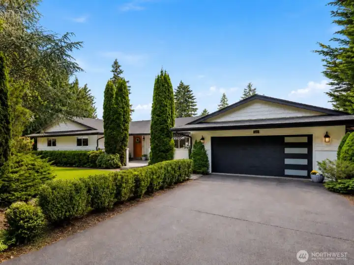 Beautifully updated home set on 1.25 private acres with mature landscaping, expansive lawn, newer garage door, and exceptional privacy in one of Gig Harbor's most desirable neighborhoods.