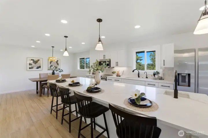 The heart of the home, offering generous seating, meal preparation space, and seamless flow to indoor and outdoor entertaining areas.