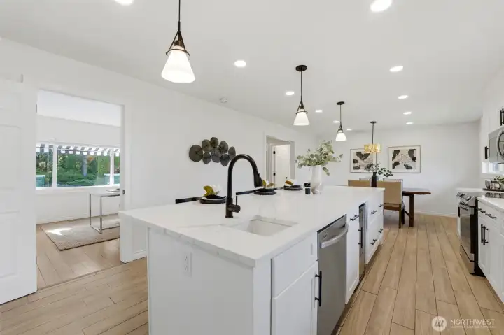 Featuring granite countertops, stainless steel appliances, an oversized island, wine refrigerator, and walk-in pantry, the kitchen flows effortlessly into a nearby office—ideal for today's work-from-home lifestyle. Not shown oversized walk-in pantry room.