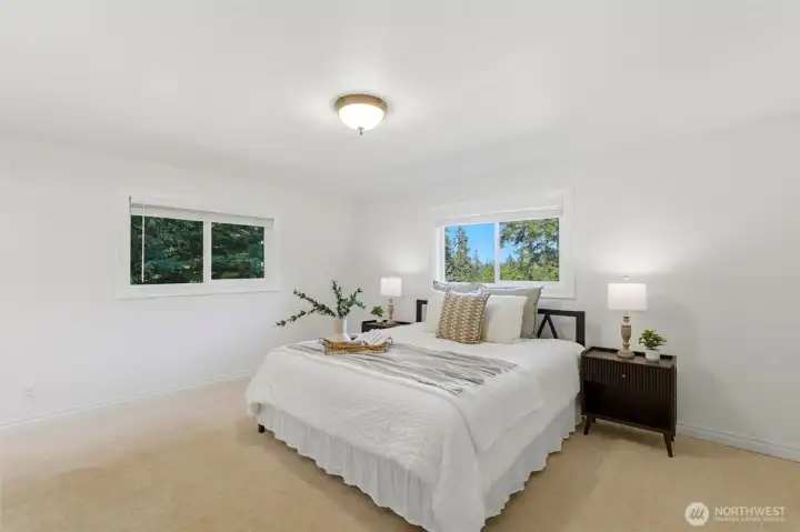 Spacious primary retreat featuring peaceful views, generous proportions, and a private ensuite bath.