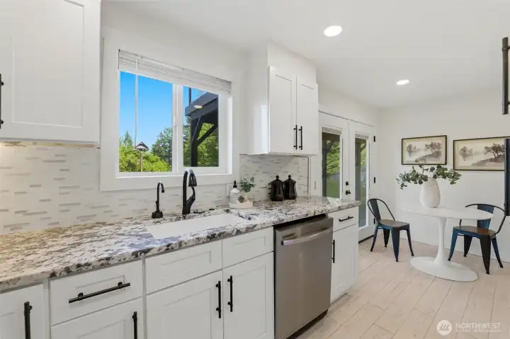Featuring a kitchenette, backyard access, and separate exterior entry, the lower level offers exceptional versatility for multi-generational living, guest accommodations, remote work, or potential rental opportunities.