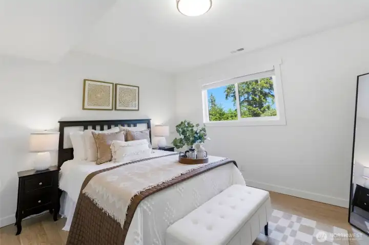 Private lower-level bedroom (1 of 2) ideal for guests or extended household living.