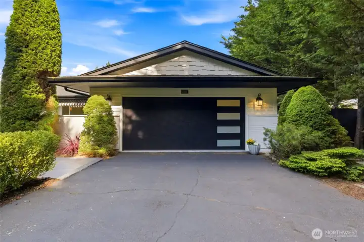 Newer roof and modern garage door enhance curb appeal while offering peace of mind. The expansive driveway provides abundant parking for guests, recreational vehicles, and everyday convenience.