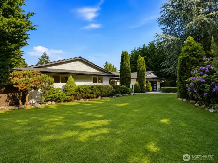 Thoughtfully designed gardens, mature trees, and established landscaping provide exceptional privacy while creating a tranquil Pacific Northwest setting on 1.25 acres in desirable Kopachuck.