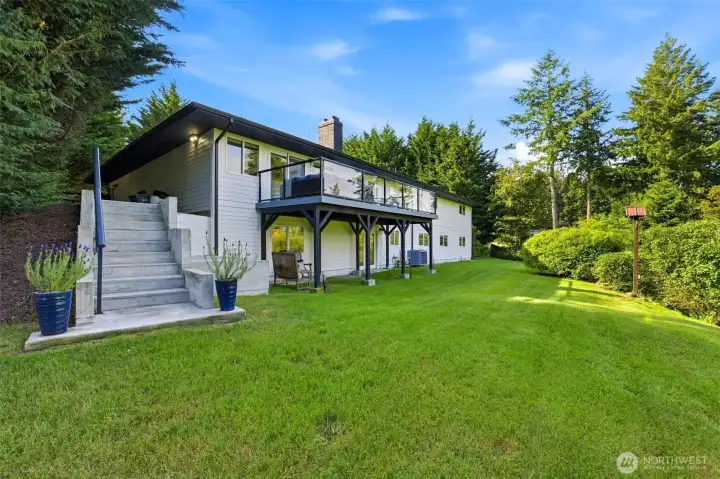 Enjoy a sheltered outdoor area beneath the deck, creating additional space for year-round entertaining, outdoor seating, storage, or hobby use regardless of the season. Updated systems, including a heat pump for efficient heating and cooling, contribute to year-round comfort and peace of mind.