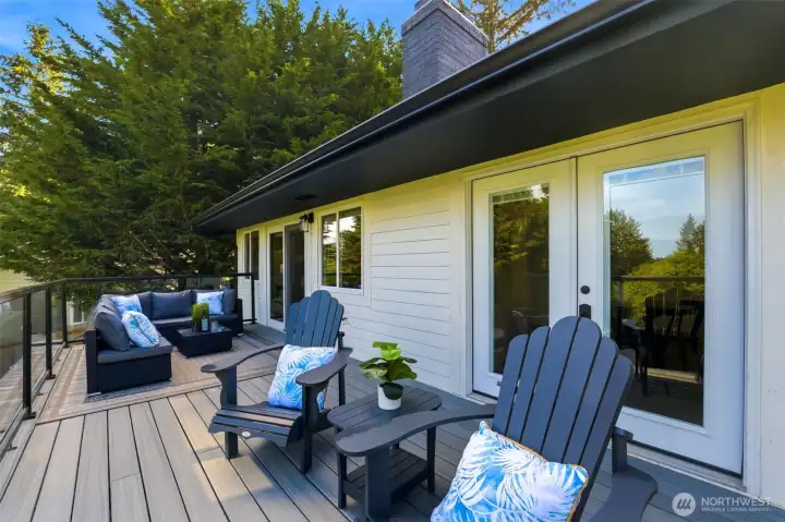 Brand-new deck overlooking private grounds, creating the perfect setting for summer gatherings, outdoor dining, and relaxation.