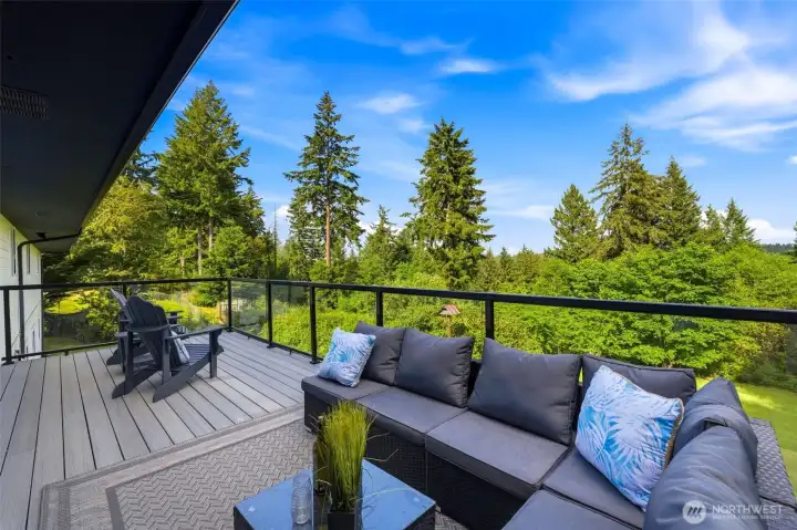 Brand-new deck overlooking private grounds, creating the perfect setting for summer gatherings, outdoor dining, and relaxation.