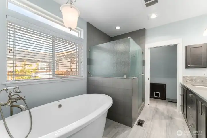 Spa-inspired primary bath offering dual vanities and a relaxing atmosphere. Spa-inspired primary bath offering dual vanities and a relaxing atmosphere.