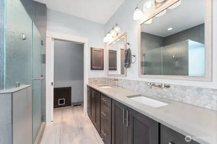 Primary bathroom with heated floors and modern finishes. Primary bathroom with heated floors and modern finishes.