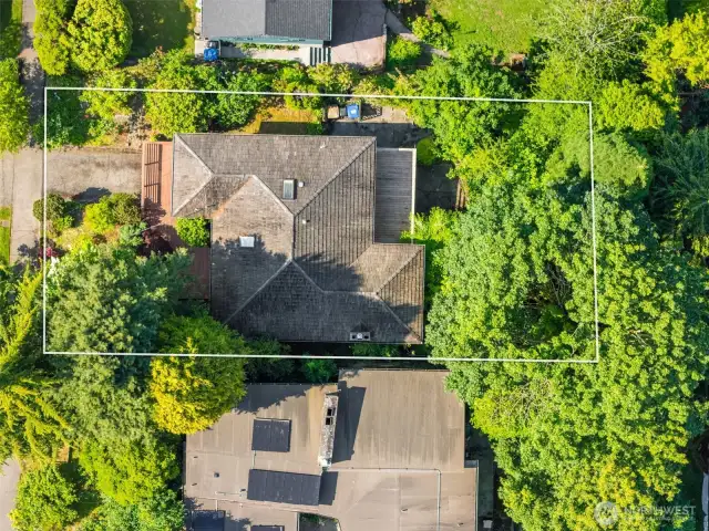 Aerial view of the home with lines approximate - yard goes beyond the chain fence in the backyard off the patio.