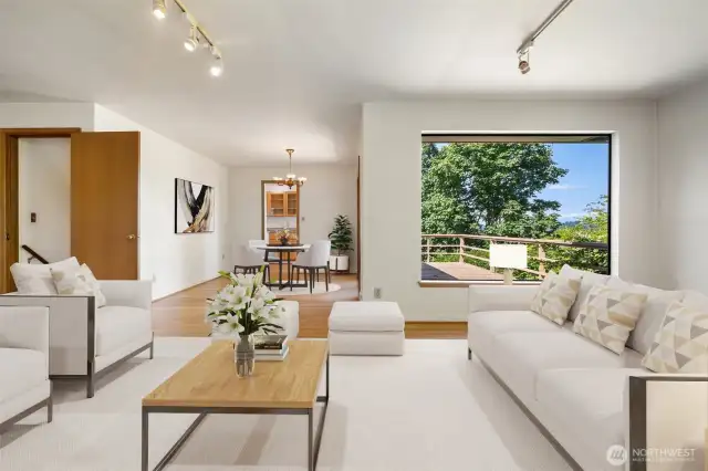 Living room with view out to deck and dining area - kitchen beyond. Virtually staged to show potential.