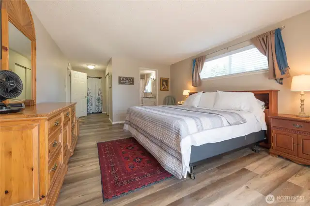 Soft, neutral tones create a calming atmosphere in the primary bedroom.