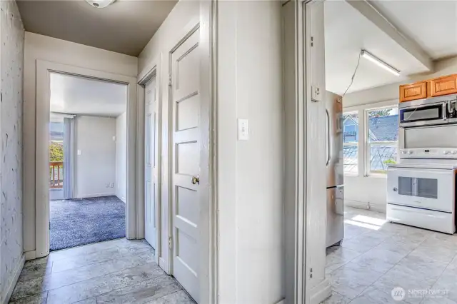 Hallway between kitchen and primary suite (stairs going down in between)