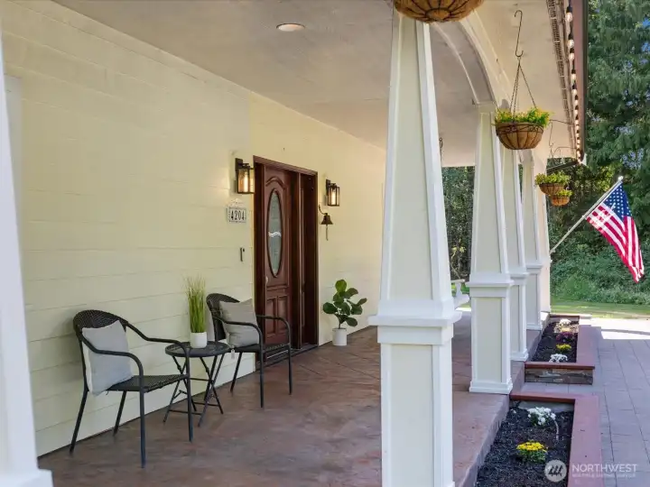 The front porch is a standout feature—stamped concrete for durability, complete with a classic porch swing for added charm.