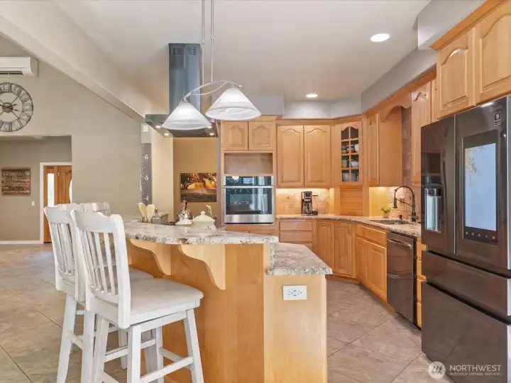 The kitchen boasts a new smart refrigerator for photos, calendar reminders, or whatever you like, along with nearly-new dishwasher, wall oven, hood, cooktop, and faucet. It even features a convenient built-in bottle and cup washer at the sink.