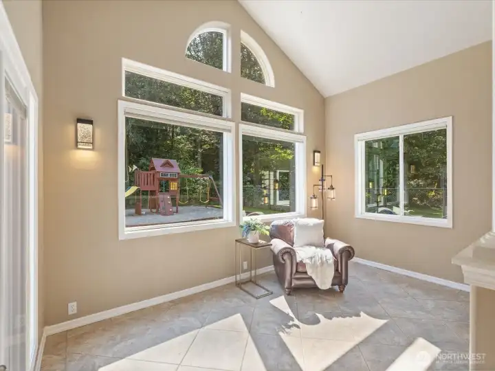 This versatile “Christmas tree” room easily transforms into a cozy sitting area year-round, offering a perfect view of backyard activity—or a quiet spot to relax.