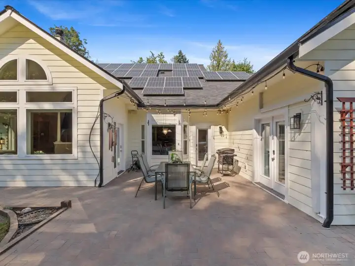 The exterior features abundant lighting and built-in irrigation, while the large solar system keeps energy costs minimal. Outdoor spaces are beautifully finished with durable pavers.