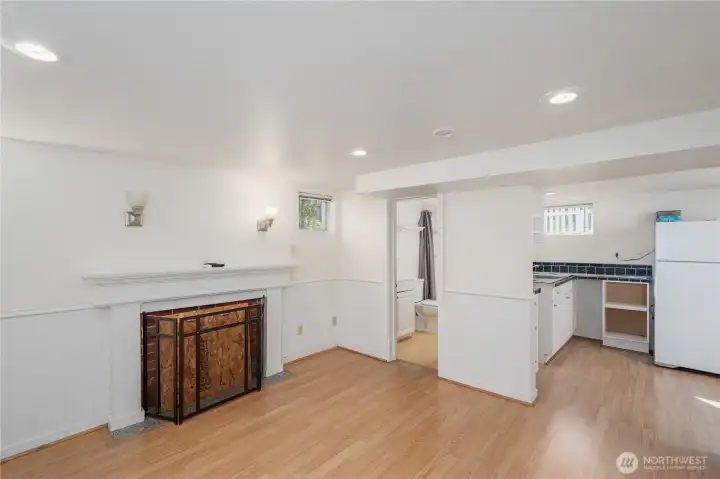 A look from the front of the house in the downstairs living area looking towards the  bathroom, kitchenette & door to the outside