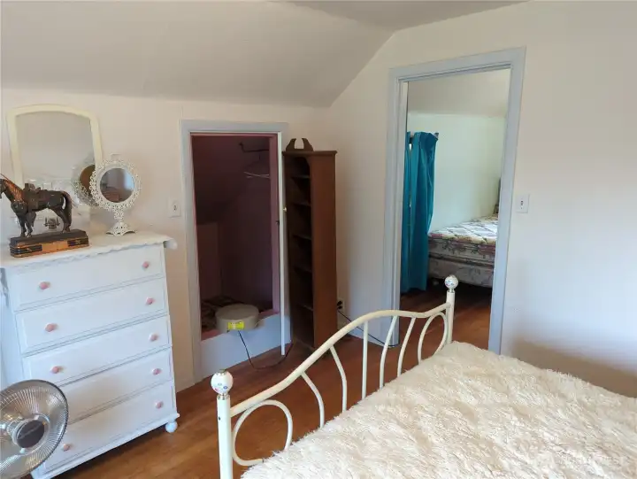 Upstairs bedroom #2 with attic storage.