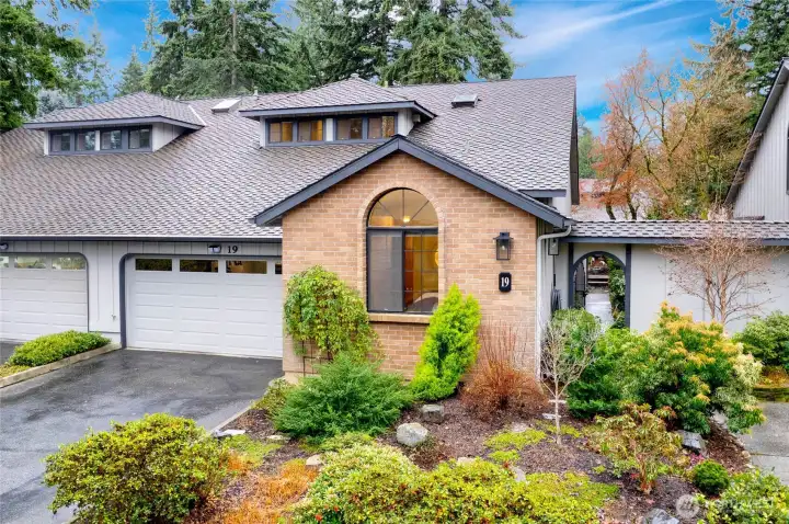 Front of home with 2-car garage and room for more in the driveway.
