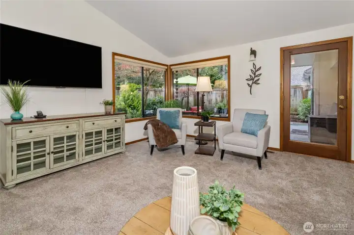 Lots of light in the living room with a door leading to the back deck and yard.