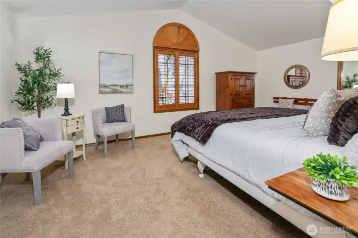 Extra large primary bedroom with vaulted ceiling.