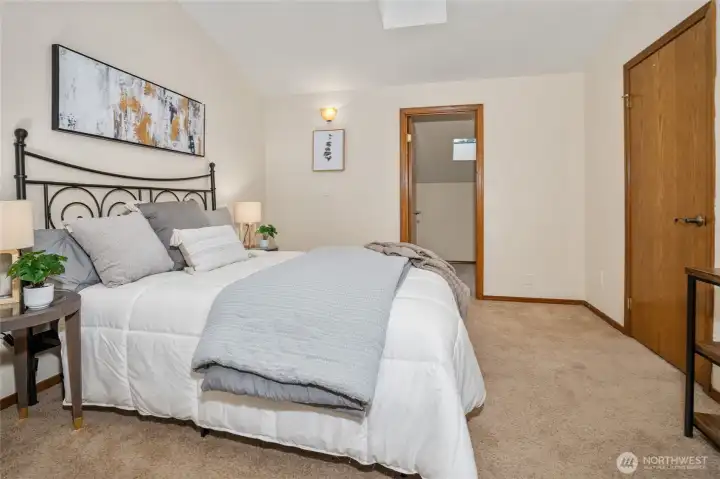 View from the second upstairs bedroom looking toward the large closet or additional storage room.
