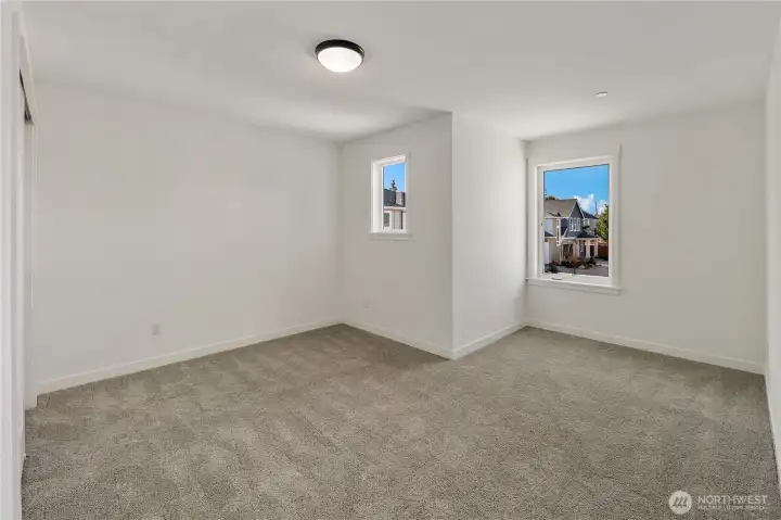 Secondary Bedroom Four  This additional upper level bedroom features a practical layout with ample wall space for flexible furniture placement. A wide window introduces natural light while maintaining privacy, and the clean architectural lines support a calm, uncluttered atmosphere. The right-sized proportions make it ideal for guests, hobbies, or a dedicated workspace.    Set within Bothell’s Canyon Park neighborhood, this well-planned room reflects the smart, space-conscious design expected in contemporary new construction homes served by the Northshore School District.    These photos are from a past Robinson Plan at a different community, so overall plan, colors, building orientation, finishes, home outlook, and other details can and WILL vary. All photos, renderings, site maps, and floorplans are for visualization purposes only.