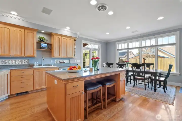 A spacious kitchen designed to seamlessly integrate the main dining area alongside inviting casual countertop seating.