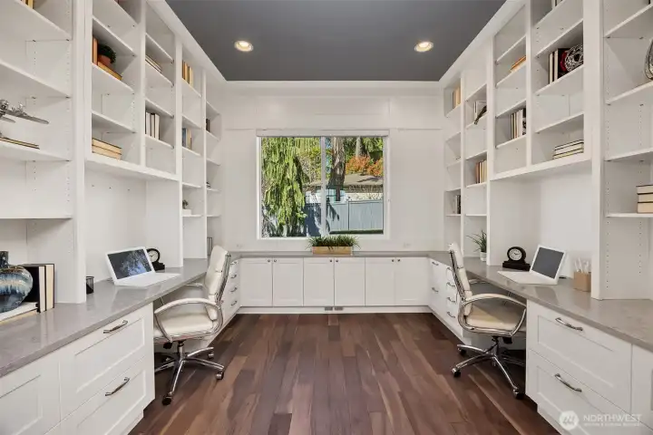 Just off the foyer is this custom office equipped with dual workstations and ample built-in storage.