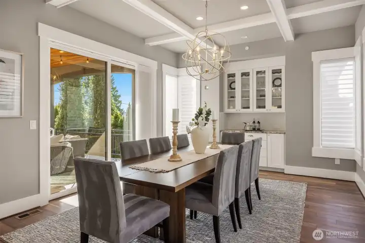 A coffered ceiling and custom buffet elevate the dining room.