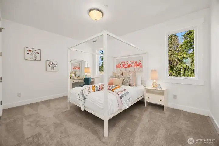 The second bedroom suite overlooks peaceful backyard views.