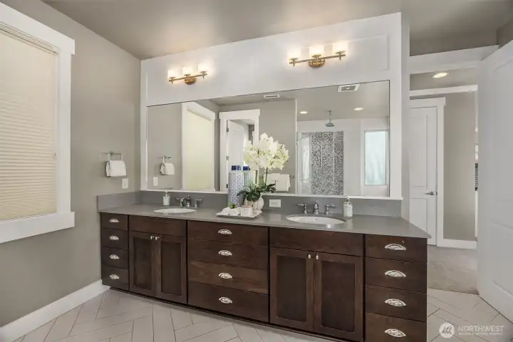 Extra large vanity with dual sinks plus a private commode room.