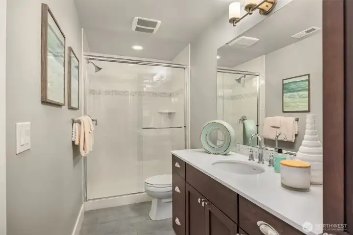 Full guest bath just around the corner from the lower bedroom.