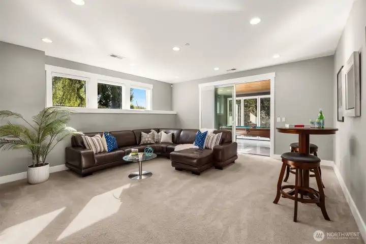 Kick back in the huge rec room opening to the flex room.