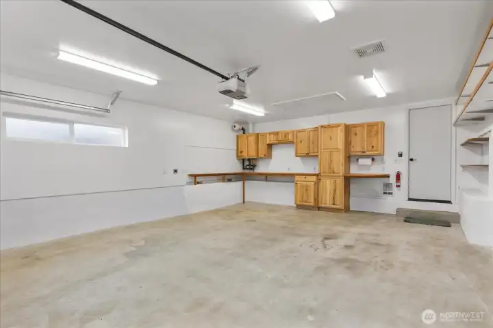 This is a garage made for your weekend projects! You will love the workbench, storage, exhaust fan and even a heat source to stay comfortable when working in here.