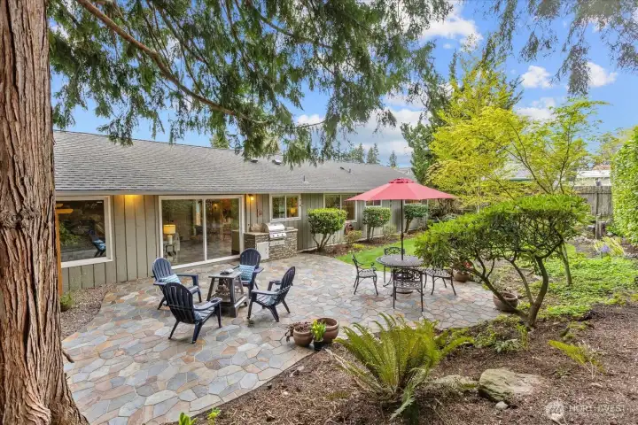 Imagine summer evening relaxing in this fenced backyard oasis on a beautiful slate patio - complete with a built in BBQ, bubbling fountain and grassy play area