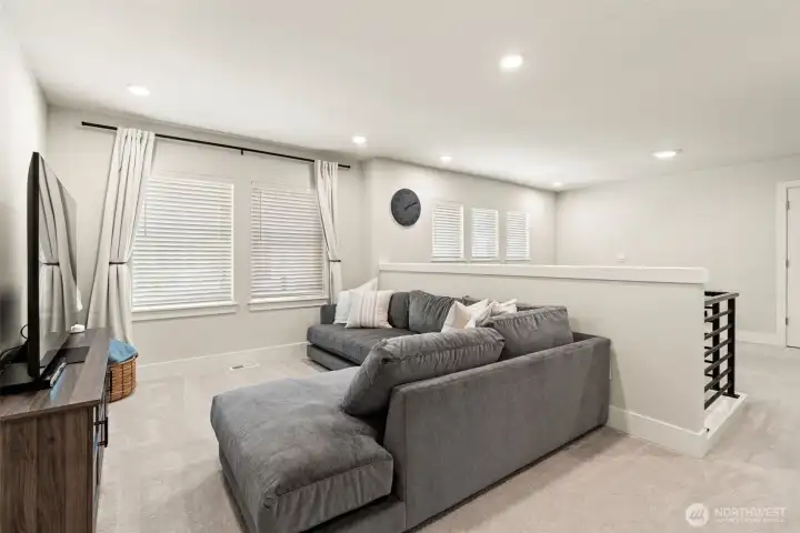 Upstairs, the bonus/loft area offers endless possibilities — movie nights, a play space, a home theater setup, or the ultimate hang-out spot. Abundant natural light make this one of the home's most versatile and beloved spaces.