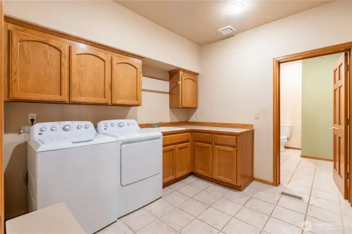 Huge laundry room with storage, a rack for hanging delicates and a sink. Also has a built in ironing board on the opposite wall. Washer and Dryer included! Huge laundry room with storage, a rack for hanging delicates and a sink. Also has a built in ironing board on the opposite wall. Washer and Dryer included!