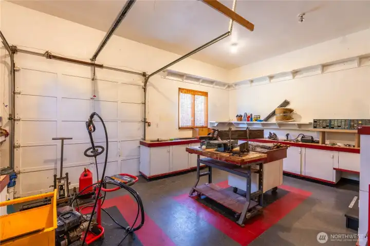 This large shop has many built-ins and work areas. The large pull up door can let in a riding lawn mower and all of your tools and accessess the back patio. This large shop has many built-ins and work areas. The large pull up door can let in a riding lawn mower and all of your tools and accessess the back patio.
